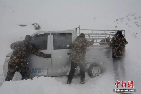 12日，新疆阿勒泰邊防官兵在救援被困車輛。（圖片來源：中新網(wǎng)）