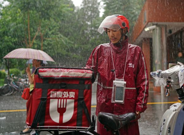 外賣送貨員在暴雨中堅持工作。新華社記者陳誠攝