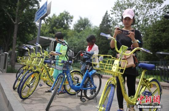 資料圖 6月8日，民眾在北京街頭掃碼租用一款“土豪金”色的共享單車。 <a target='_blank' href='http://www.chinanews.com/'>中新社</a>記者 楊可佳 攝