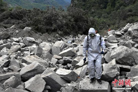 6月26日，四川茂縣疊溪鎮(zhèn)新磨村新村組富貴山“6·24”特別重大山體滑坡災(zāi)害搜救工作進入第3天，上千名救援人員堅守現(xiàn)場全力搜救。圖為防疫人員進行消毒防疫。 中新社記者 安源 攝